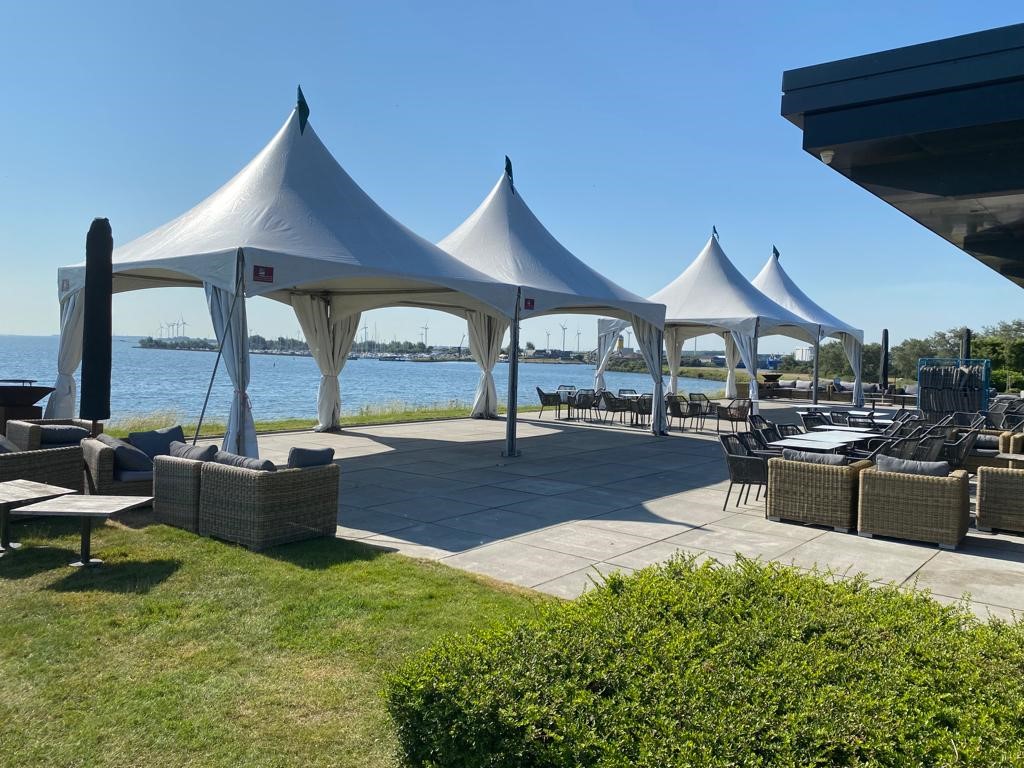 Pagodes gekoppeld met open zijkantzeilen op terras Span tenten